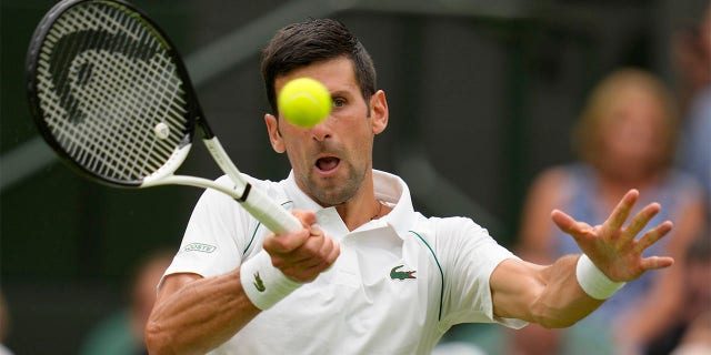 Serbia's Novak Djokovic returns to Korea's Kwon Soonwoo in a men's first round singles match on day one of the Wimbledon tennis championships in London, Monday, June 27, 2022. 