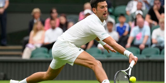 Serbia's Novak Djokovic returns to Korea's Kwon Soonwoo in a men's first round singles match on day one of the Wimbledon tennis championships in London, Monday, June 27, 2022. 