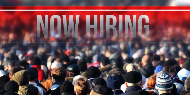 a photo of a now hiring sign