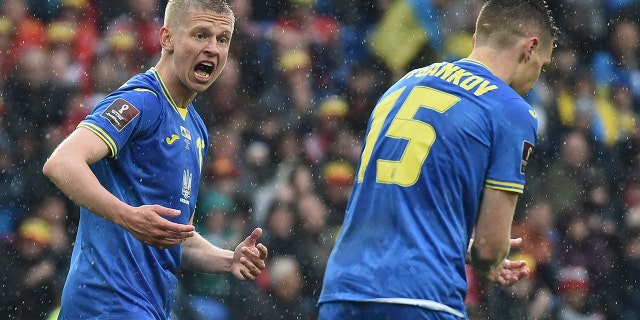 Ukraine's Oleksandr Zinchenko, left, and Viktor Tsygankov during the World Cup 2022 qualifying match between Wales and Ukraine at Cardiff City Stadium, in Cardiff, Wales, Sunday, June 5, 2022.