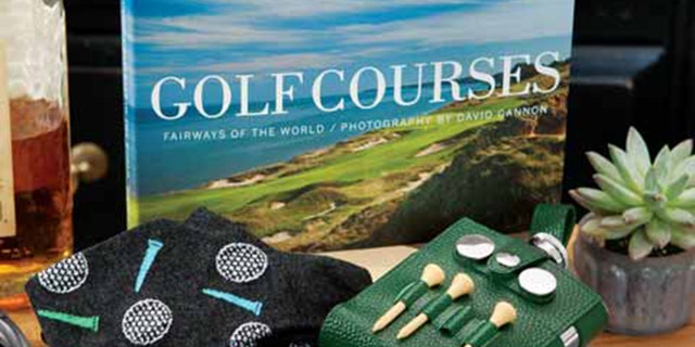 This wooden crate contains photos of venues, golf socks and more.(Courtesy of Olive & Cocoa)