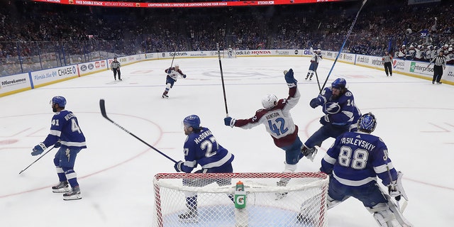 Josh Manson #42 of the Colorado Avalanche collides with Pat Maroon #14 of the Tampa Bay Lightning in the second period of Game Six of the 2022 NHL Stanley Cup Final at Amalie Arena on June 26, 2022 in Tampa, Florida.