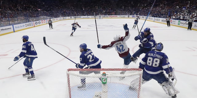 Josh Manson #42 of the Colorado Avalanche collides with Pat Maroon #14 of the Tampa Bay Lightning in the second period of Game Six of the 2022 NHL Stanley Cup Final at Amalie Arena on June 26, 2022 in Tampa, Florida.