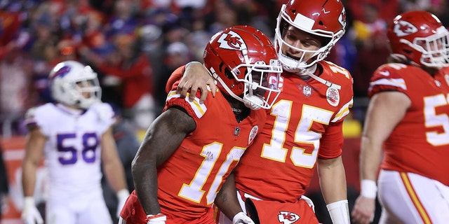 Tyreek Hill #10 of the Kansas City Chiefs celebrates with teammate Patrick Mahomes #15 after scoring a 64 yard touchdown against the Buffalo Bills during the fourth quarter in the AFC Divisional Playoff game at Arrowhead Stadium on January 23, 2022 in Kansas City, Missouri.