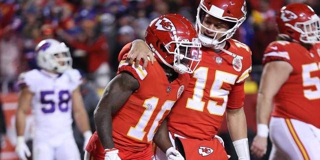 Tyreek Hill #10 of the Kansas City Chiefs celebrates with teammate Patrick Mahomes #15 after scoring a 64 yard touchdown against the Buffalo Bills during the fourth quarter in the AFC Divisional Playoff game at Arrowhead Stadium on January 23, 2022 in Kansas City, Missouri.