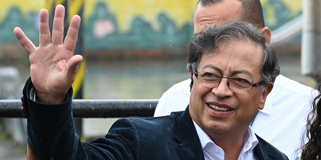 The Colombian presidential candidate for the Historic Pact coalition, Gustavo Petro, waves as he arrives at a polling station to cast his vote during the presidential election, in Bogota on May 29, 2022.