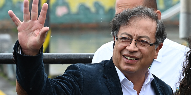 The Colombian presidential candidate for the Historic Pact coalition, Gustavo Petro, waves as he arrives at a polling station to cast his vote during the presidential election, in Bogota on May 29, 2022.