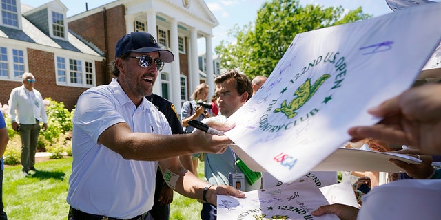 Phil Mickelson signs autographs after a practice round for the U.S. Open golf tournament at The Country Club, Wednesday, June 15, 2022, in Brookline, Mass.