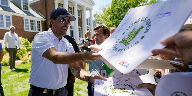 Phil Mickelson signs autographs after a practice round for the U.S. Open golf tournament at The Country Club, Wednesday, June 15, 2022, in Brookline, Mass.