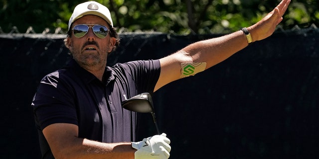 Phil Mickelson watches his tee shot on the fifth hole during a practice round ahead of the U.S. Open June 14, 2022, at The Country Club in Brookline, Mass.