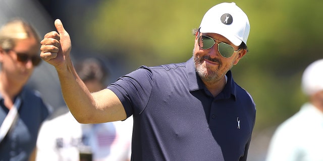 Phil Mickelson gives a thumbs up to cheering fans during his practice round at the Brookline Country Club on June 14, 2022.