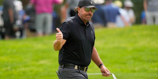 Phil Mickelson reacts to the crowd on the eighth hole during the first round of the U.S. Open golf tournament at The Country Club, Thursday, June 16, 2022, in Brookline, Mass.