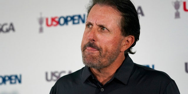 Phil Mickelson ponders a question at a press conference, Monday, June 13, 2022, at The Country Club in Brookline, Massachusetts, ahead of the U.S. Open golf tournament.