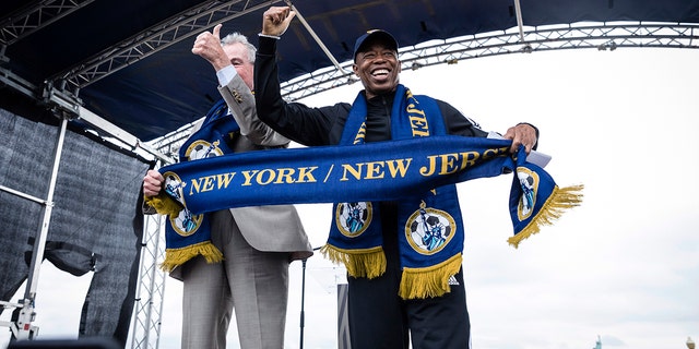 New Jersey Gov. Phil Murphy, left, and New York City Mayor Eric Adams speak at the 2026 FIFA World Cup host city selection watch party at Liberty State Park in Jersey City, Thursday, June 16, 2022.