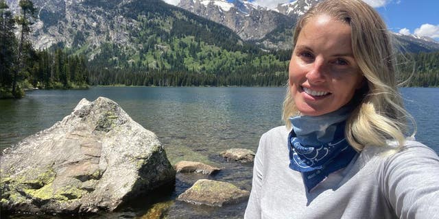 Heather Mycoskie poses for a selfie alongside Grand Teton National Park's Taggart Lake during a hike in 2020.