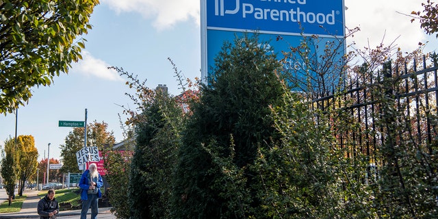 Planned Parenthood protesters pray outside the Columbus location