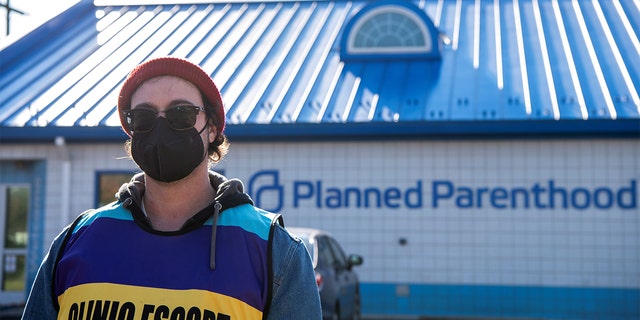 Volunteer clinic escort Kaleb Masterson outside of a Planned Parenthood in Columbus, Ohio, Nov. 12, 2021.