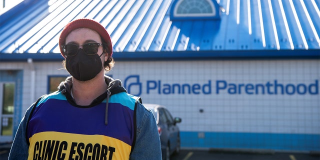 Volunteer clinic escort Kaleb Masterson outside of a Planned Parenthood in Columbus, Ohio, Nov. 12, 2021.