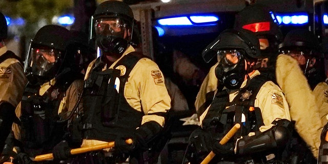 Police in riot gear surround the Arizona Capitol after protesters reached the front of the Arizona Senate building as protesters reacted to the Supreme Court decision to overturn the landmark Roe v. Wade abortion decision Friday, June 24, 2022, in Phoenix. (AP Photo/Ross D. Franklin)