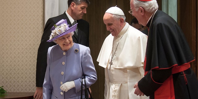 Queen Elizabeth II meets Pope Francis, center, and former Archbishop of Westminster Cardinal Cormack Murphy O'Connor at the Paul VI Hall in Vatican City on April 3, 2014.