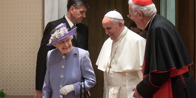 Queen Elizabeth II meets Pope Francis, center, and former Archbishop of Westminster Cardinal Cormack Murphy O'Connor at the Paul VI Hall in Vatican City on April 3, 2014.