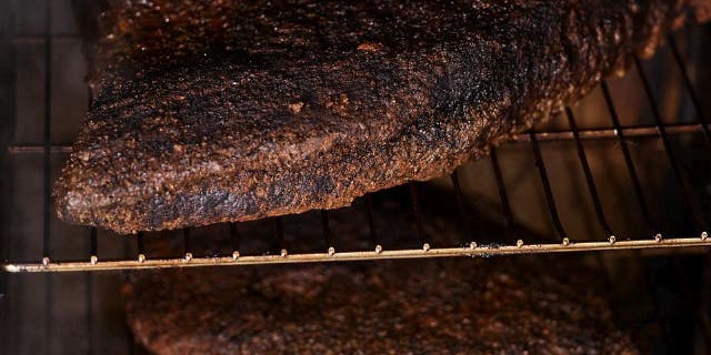 Classic smoked beef brisket is cooked in a smoker between 10.5 and 12 hours.