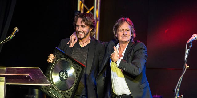 Rick Springfield presents award to Brett Tuggle at the RockGodz Hall Of Fame Annual Induction Ceremony at The Canyon Club on Oct. 27, 2019 in Agoura Hills, California. 