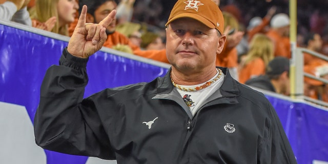 Former UT Longhorn pitcher, Houston Astro and 7-time Cy Young winner Roger Clemens gives a Hook 'Em Horns sign from the sideline during the Texas Bowl game between the Texas Longhorns and the Missouri Tigers on December 27, 2017 at NRG Stadium in Houston, Texas.