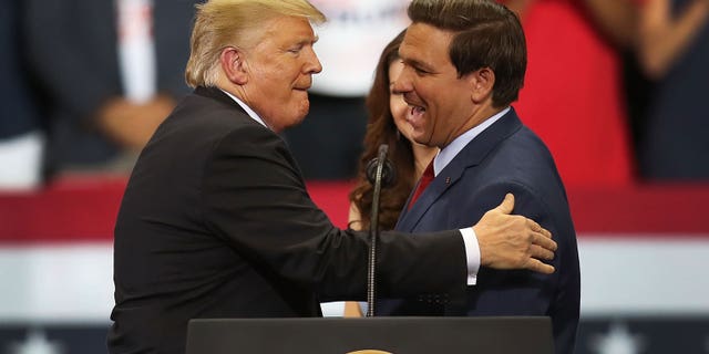 Florida Gov.  Ron DeSantis with former President Donald Trump at a rally. 