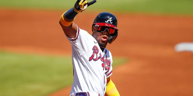 Ronald Acuna Jr. #13 of the Atlanta Braves reacts after hitting a lead-off home run in the first inning of an MLB game against the Pittsburgh Pirates at Truist Park on May 22, 2021 in Atlanta, Georgia. 
