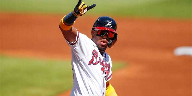 Ronald Acuna Jr. #13 of the Atlanta Braves reacts after hitting a lead-off home run in the first inning of an MLB game against the Pittsburgh Pirates at Truist Park on May 22, 2021 in Atlanta, Georgia. 