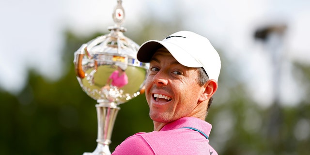 Northern Ireland's Rory McIlroy celebrates the trophy after winning the RBC Canadian Open at the St. Georges Golf and Country Club in Etobicoke, Ontario on June 12, 2022.