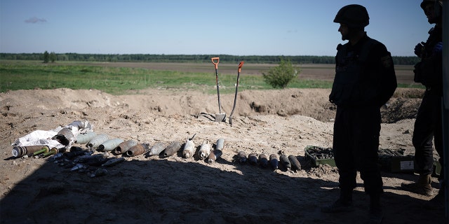 Bomb disposal experts from the Ukrainian State Emergency Service prepare for a controlled explosion of 1 ton of unexploded missiles, artillery shells and mines that they have retrieved during the last week in the Borodianka area on June 3, 2022, in Borodianka, Ukraine.