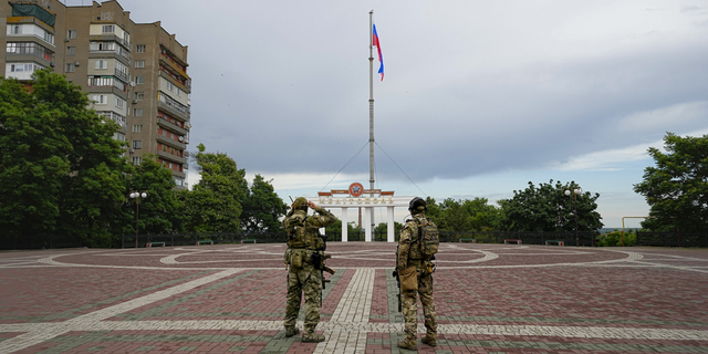 Russian soldiers guard an area under Russian military control in Melitopol, in the Zaporizhzhia region, southeastern Ukraine,  on Tuesday, June 14.