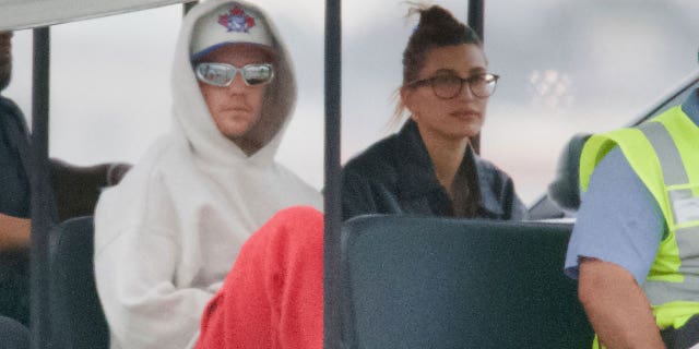 Justin Bieber and wife Hailey were photographed arriving back to Los Angeles after spending time together on a Bahamas beach vacation. Bieber seemed in good spirits as he sat with wife Hailey Bieber by his side after deboarding. 