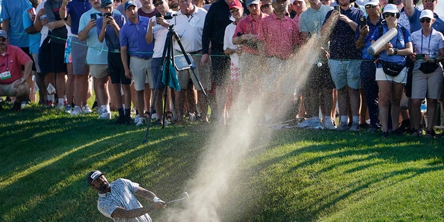 Sahith Theegala hits out of a bunker on the 18th hole on his second attempt at the shot during the final round of the Travelers Championship golf tournament at TPC River Highlands, Sunday, June 26, 2022, in Cromwell, Conn.