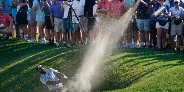 Sahith Theegala hits out of a bunker on the 18th hole on his second attempt at the shot during the final round of the Travelers Championship golf tournament at TPC River Highlands, Sunday, June 26, 2022, in Cromwell, Conn.