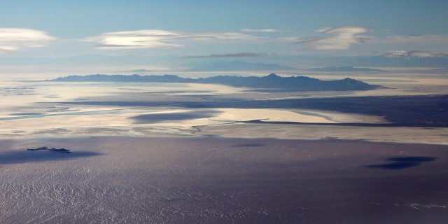 The salt covered lake bed and saline waters of the Great Salt Lake are pictured from north of Salt Lake City, Utah, April 14, 2020.