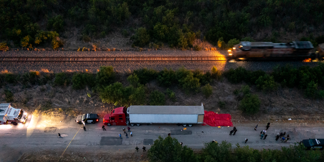  In this aerial view, members of law enforcement investigate a tractor trailer on June 27, 2022, in San Antonio, Texas. 