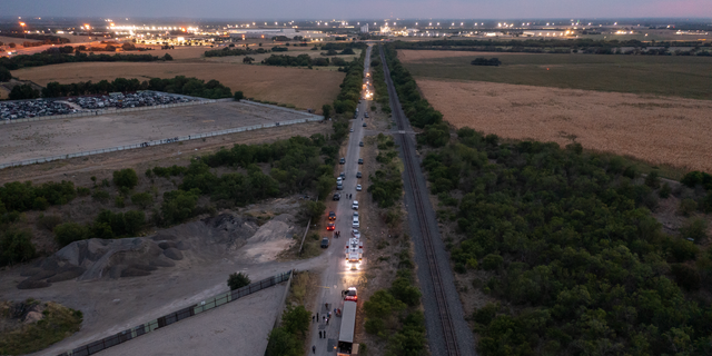 LÊER: In this aerial view, members of law enforcement investigate a tractor trailer on June 27, 2022 in San Antonio, Texas. 