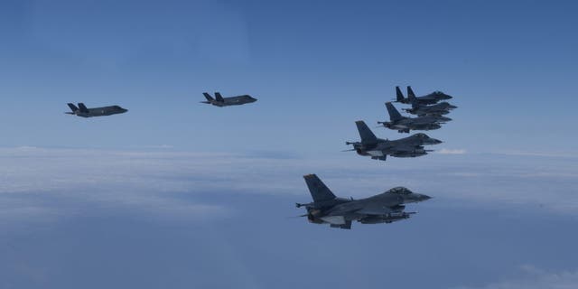 FILE - In this photo provided by South Korea Defense Ministry, U.S. and South Korea Air Force fighter jets fly in formation during a joint drill, June, 7, 2022. 