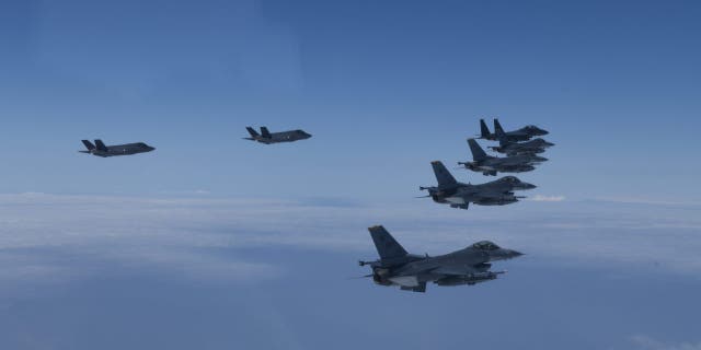 FILE - In this photo provided by South Korea Defense Ministry, U.S. and South Korea Air Force fighter jets fly in formation during a joint drill, June, 7, 2022.
