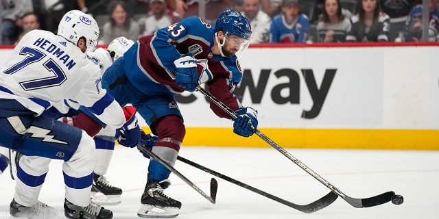 Colorado Avalanche center Darren Helm (43) shoots for a goal during the second period against the Tampa Bay Lightning in Game 2 of the NHL hockey Stanley Cup Final, Saturday, June 18, 2022, in Denver. (AP Photo/John Locher)