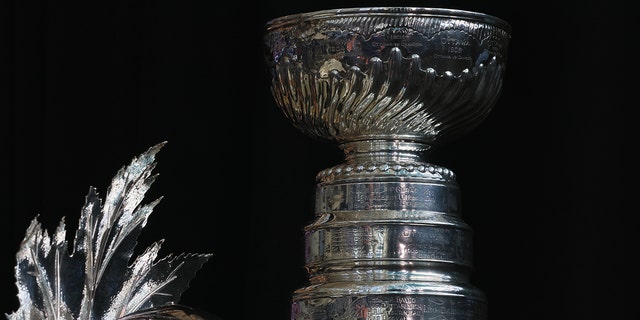 The Conn Smythe Trophy and the Stanley Cup are on display during the 2022 NHL Stanley Cup Final Media Day at Ball Arena on June 14, 2022 in Denver, Colorado.
