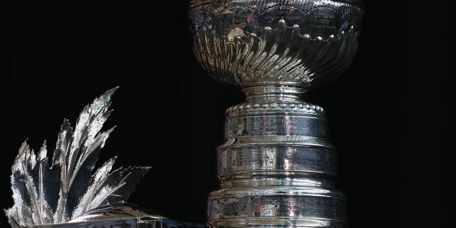 The Conn Smythe Trophy and the Stanley Cup are on display during the 2022 NHL Stanley Cup Final Media Day at Ball Arena on June 14, 2022 in Denver, Colorado.