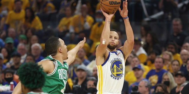 Golden State Warriors guard Stephen Curry (30) shoots against the Boston Celtics during the first half of Game 2 of the NBA Basketball Finals in San Francisco, Sunday, June 5, 2022.