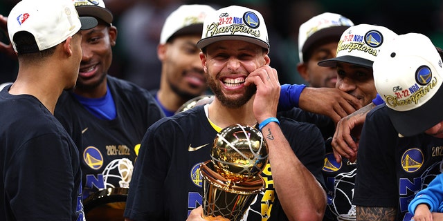 Stephen Curry #30 of the Golden State Warriors celebrates with the Bill Russell NBA Finals Most Valuable Player Award after defeating the Boston Celtics 103-90 in Game Six of the 2022 NBA Finals at TD Garden on June 16, 2022 in Boston, Massachusetts.