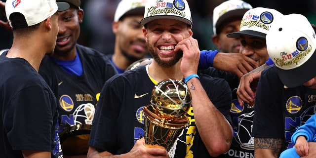 Stephen Curry #30 of the Golden State Warriors celebrates with the Bill Russell NBA Finals Most Valuable Player Award after defeating the Boston Celtics 103-90 in Game Six of the 2022 NBA Finals at TD Garden on June 16, 2022 in Boston, Massachusetts.