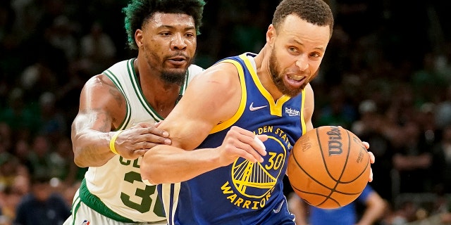 Golden State Warriors guard Stephen Curry (30) drives against Boston Celtics guard Marcus Smart (36) during the fourth quarter of Game 6 of the NBA Finals Thursday, June 16, 2022, in Boston.