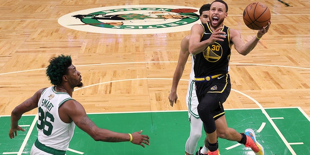 Golden State Warriors guard Stephen Curry goes up for a shot against the Celtics Wednesday, June 8, 2022, in Boston.
